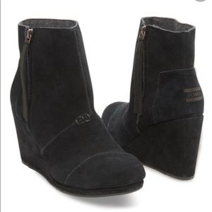 Tom’s black suede shoes